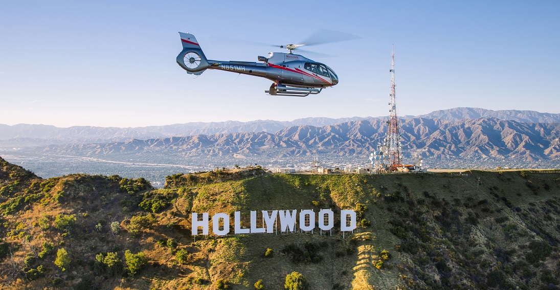 A Maverick Helicopter flying above the iconic Los Angeles landmarks during the California Hollywood and Beyond tour.